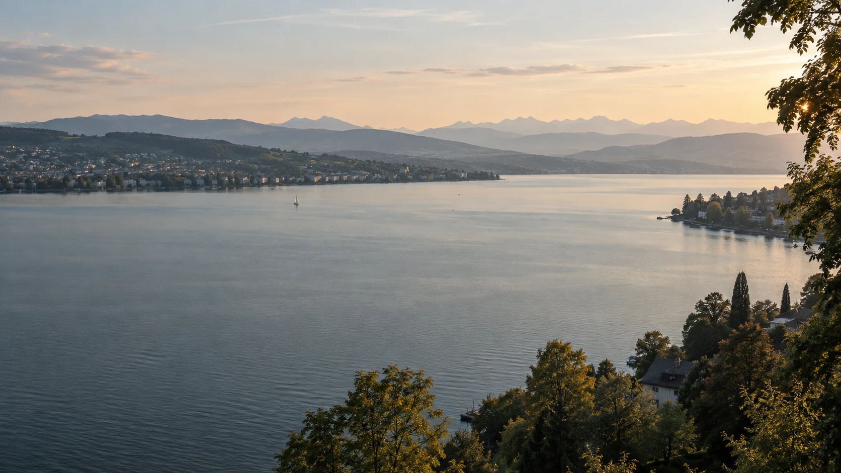 Lake Zurich in soft dawn light with wooded shores and distant hills