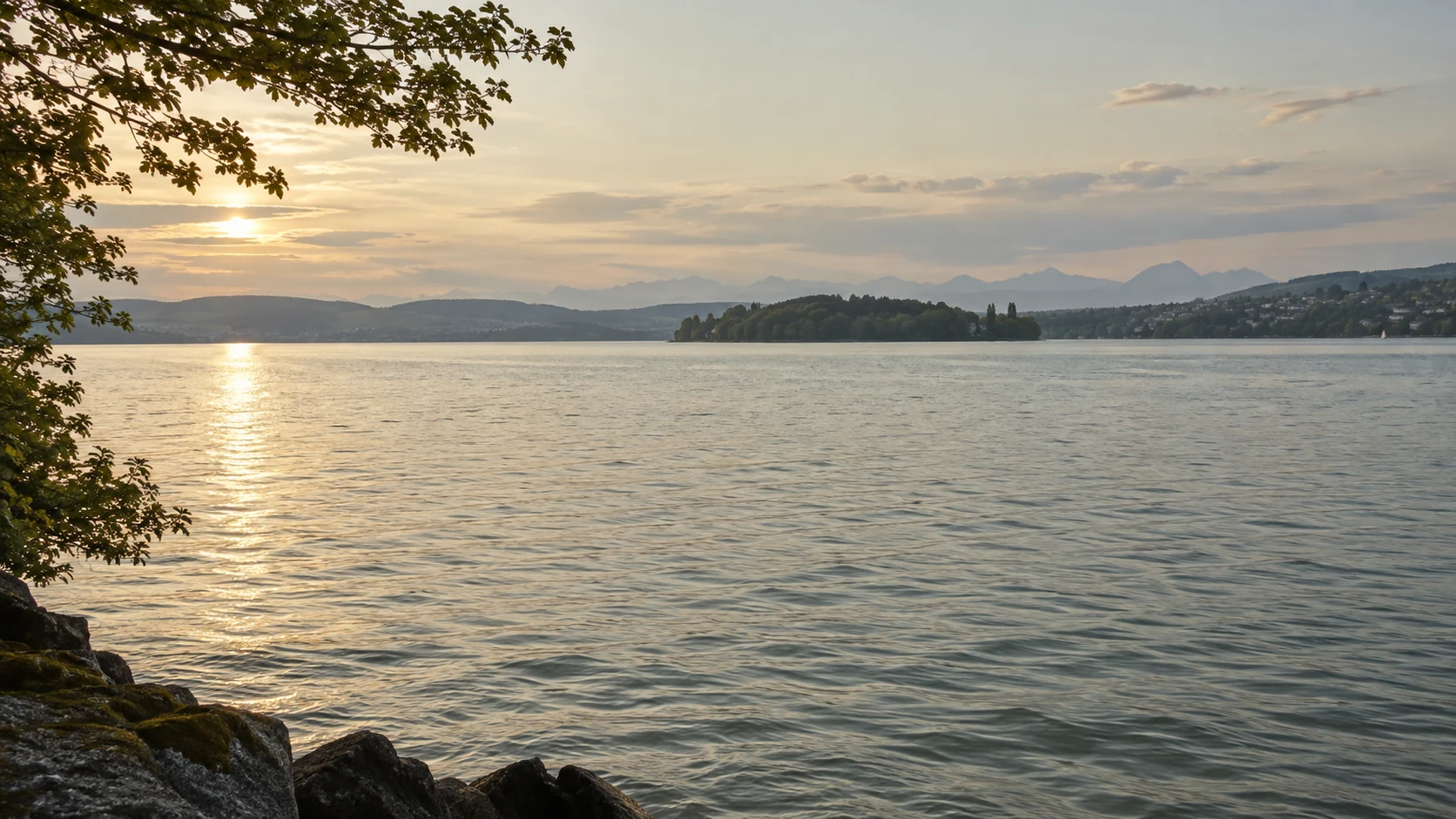 Soft evening light across Lake Zurich toward a low wooded island