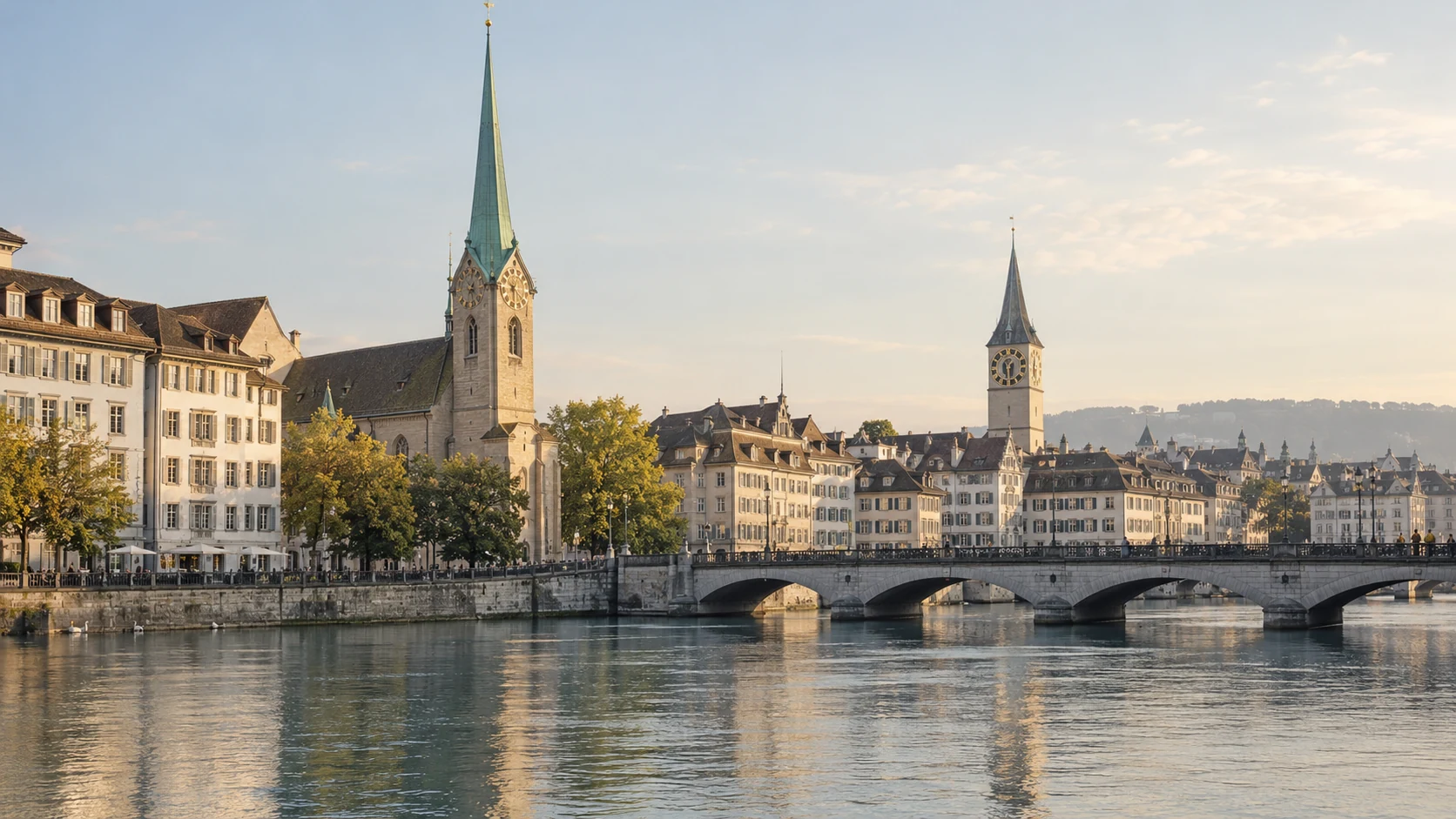 The Limmat, a stone bridge and the green spire of the Fraumünster
